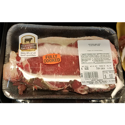 Raw meat labeled by the grocery store as fully cooked.